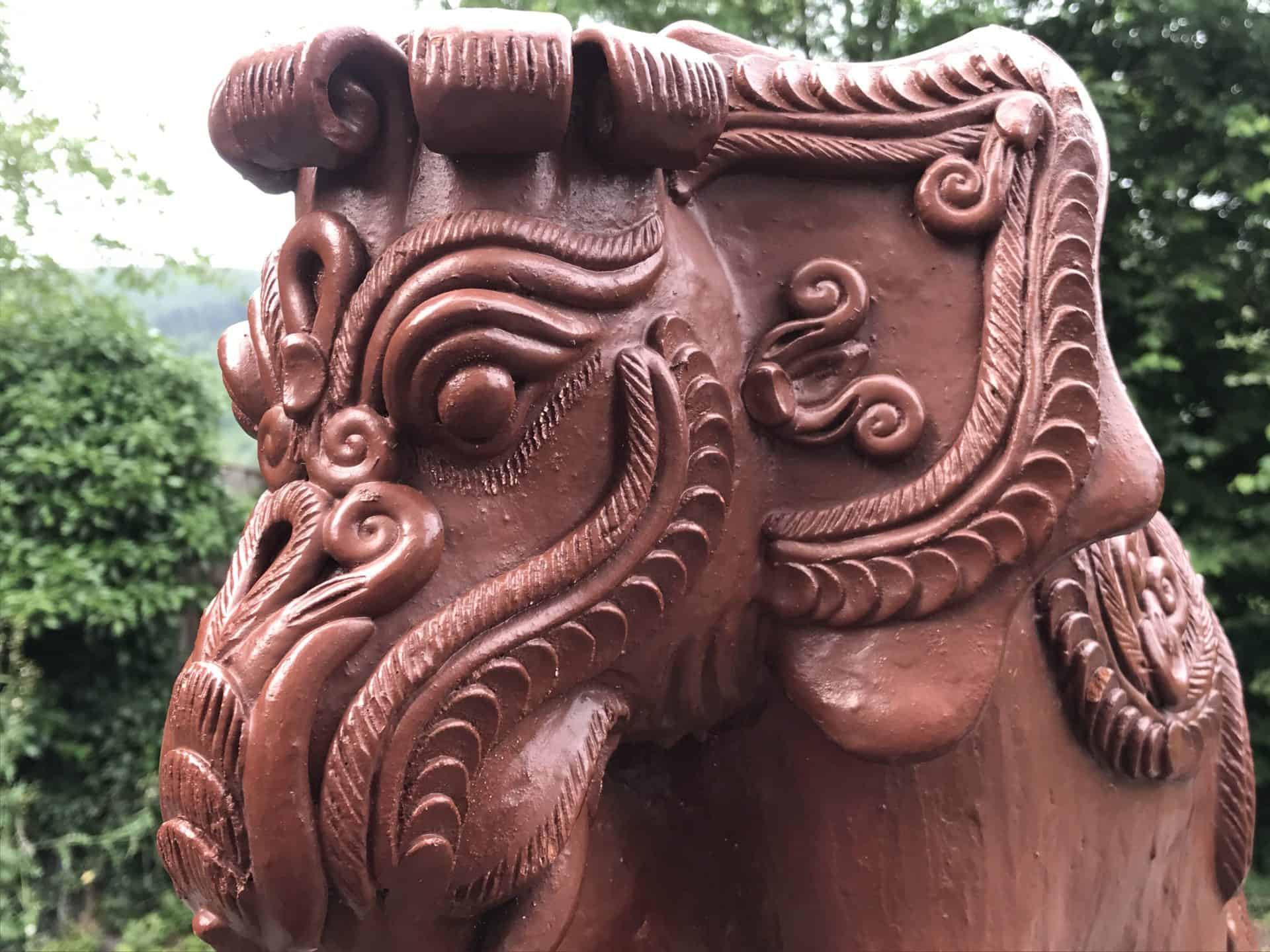 Close-up of the head of a Javanese terracotta elephant moneybox showing ornate carvings