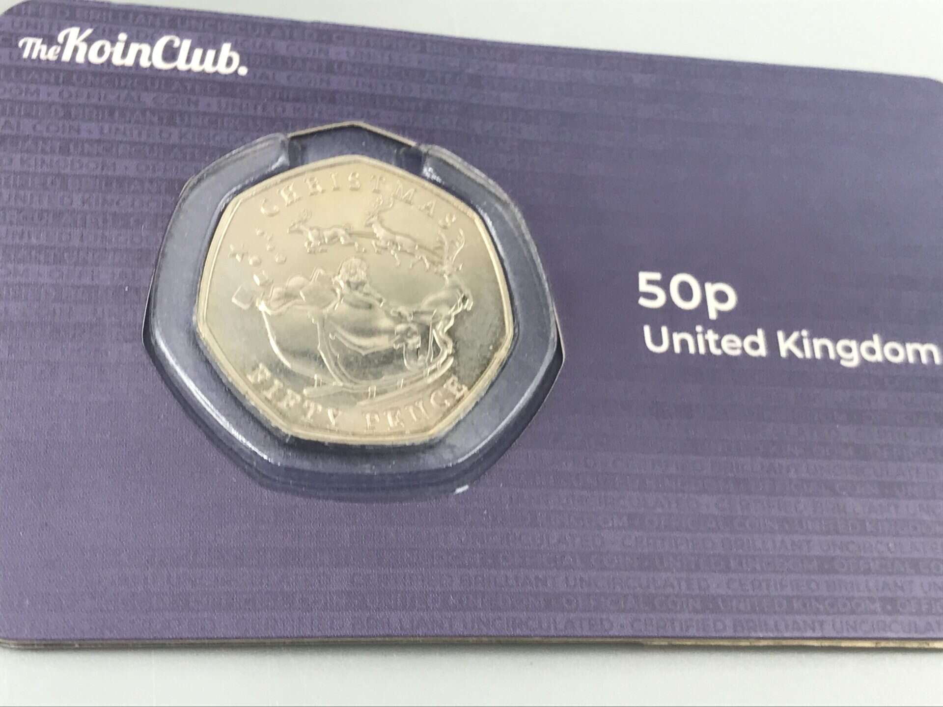 United Kingdom Christmas-themed 50p coin in The Koin Club presentation card featuring Santa and reindeer design