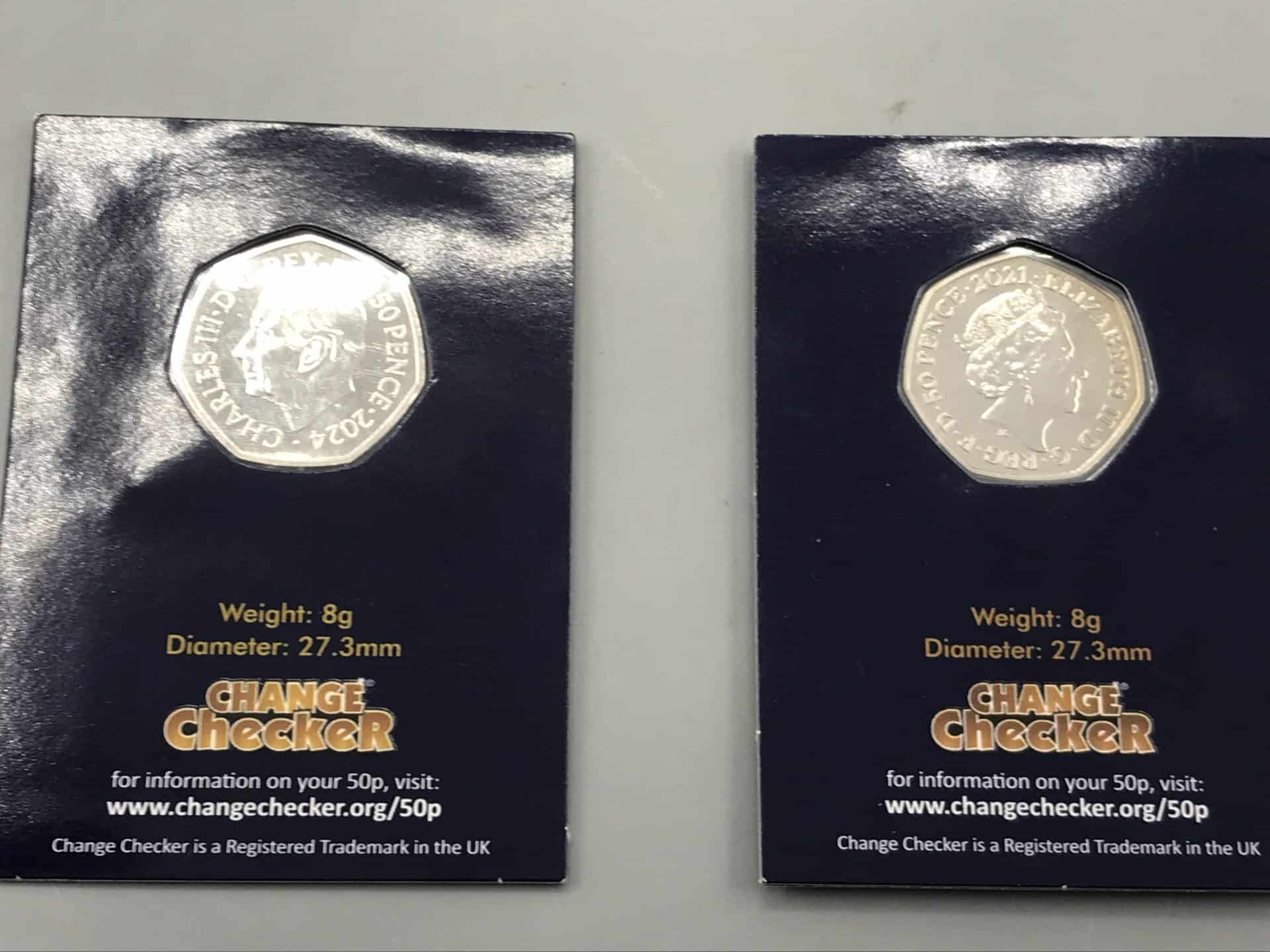Two Change Checker uncirculated UK 50p coins showing King Charles III (2022) and Queen Elizabeth II (2021) portraits in navy presentation cards