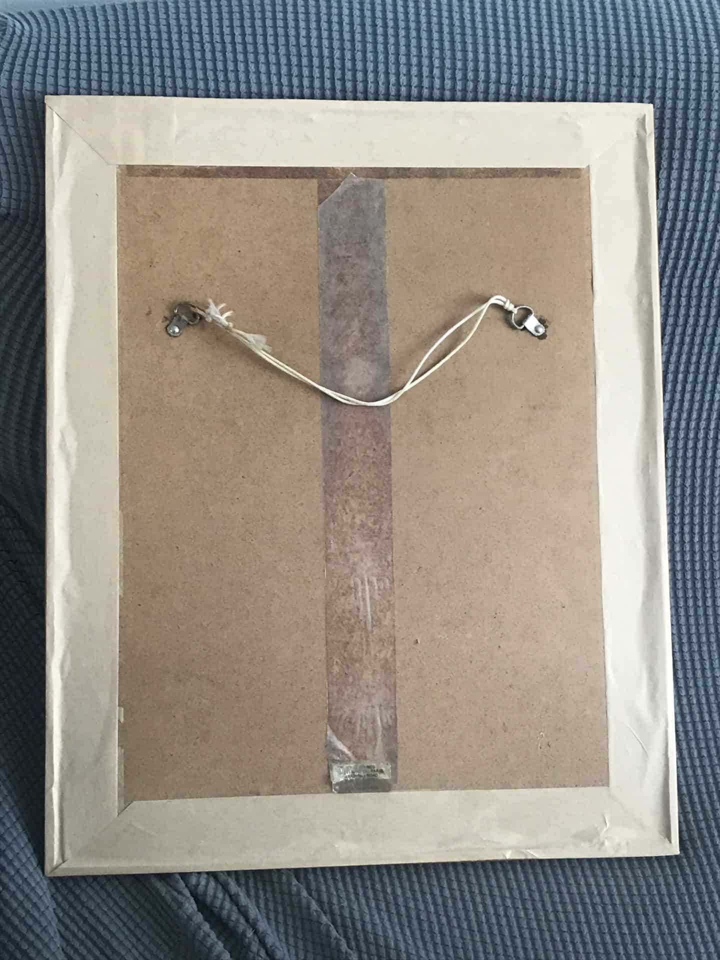 Back view of a framed vintage Japanese geisha embroidery artwork.