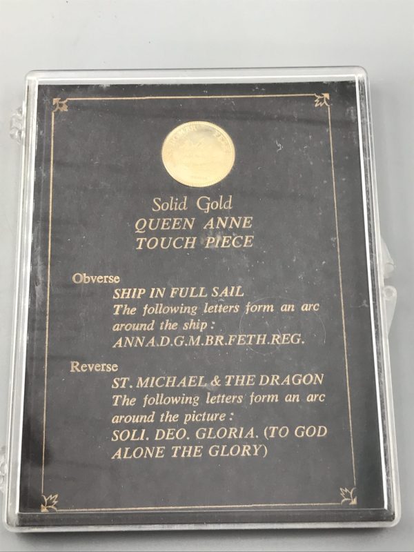 Presentation case containing a gold Queen Anne Touch Piece with printed details describing the obverse and reverse designs.