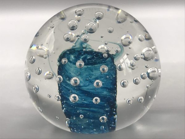 Front view of a Murano glass paperweight featuring a blue swirl core surrounded by suspended bubbles in clear glass