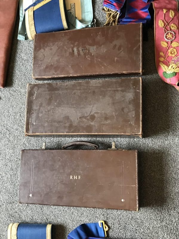 Three vintage Masonic leather regalia cases with initials and wear marks
