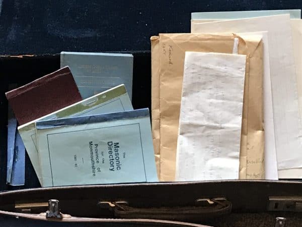 Close-up of vintage Masonic directories and ephemera inside a leather case