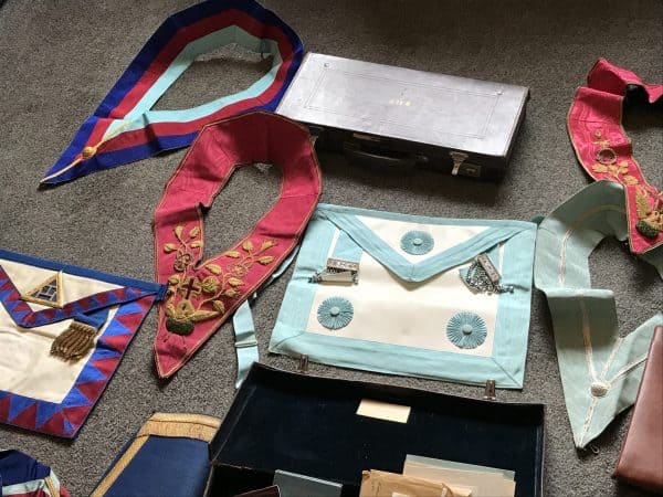 Selection of Masonic regalia including aprons, collars, and case