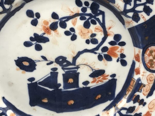 Close-up of 18th century Kangxi Chinese Imari porcelain plate pattern, showing cobalt blue, iron-red, and gilt floral and panel decoration