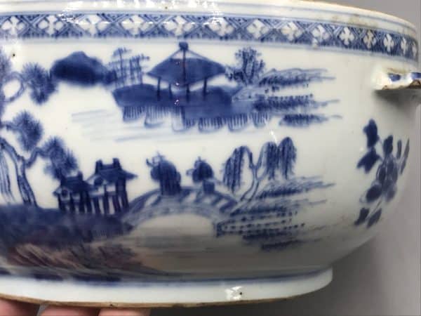 Close-up detail of 18th century Chinese export porcelain tureen, Qianlong era, showing blue and white landscape scene with trees and distant buildings