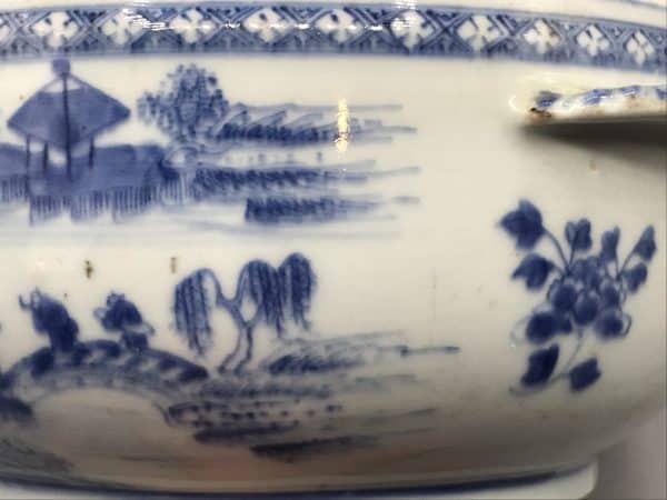 Close-up of 18th century Chinese export porcelain tureen, Qianlong era, showing blue and white hand-painted landscape with trees and pavilion