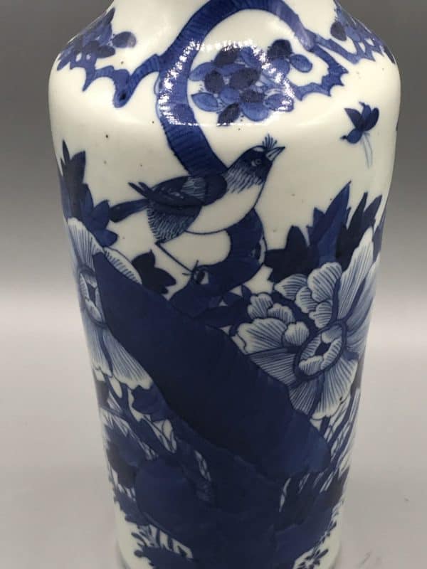Detailed view of 1920s Chinese porcelain vase pattern with bird, floral, and butterfly motifs in cobalt blue