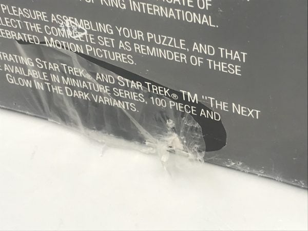 Close-up of 1993 Star Trek V The Final Frontier limited edition puzzle box showing small tear in original factory shrink wrap