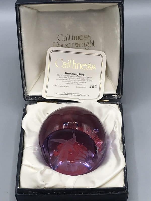 Open Caithness Glass presentation box showing hummingbird paperweight and original certificate, approximately 3.5 inches diameter