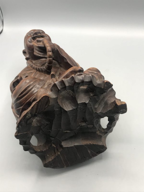 Base view of antique Chinese carved hardwood Buddha statue, showing underside construction and small area of damage
