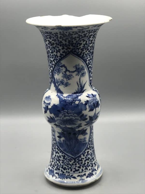 Late 19th century Chinese porcelain gu-form beaker vase with blue and white floral and bird decoration, standing 9.75 inches tall