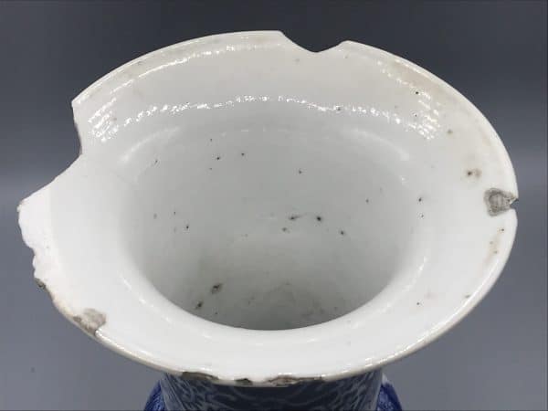 Close-up of top rim on late 19th century Chinese porcelain gu-form vase, showing glaze imperfections and rim damage