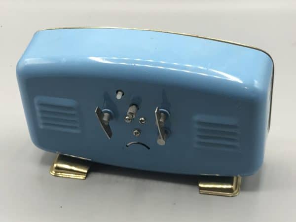 Back view of mid-century Polaris Chinese mechanical alarm clock in blue metal case with dual winders
