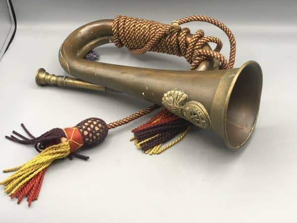 Antique brass and copper bugle with Royal Welch Fusiliers 23rd Regiment badge and original cord, measuring 11.5 inches