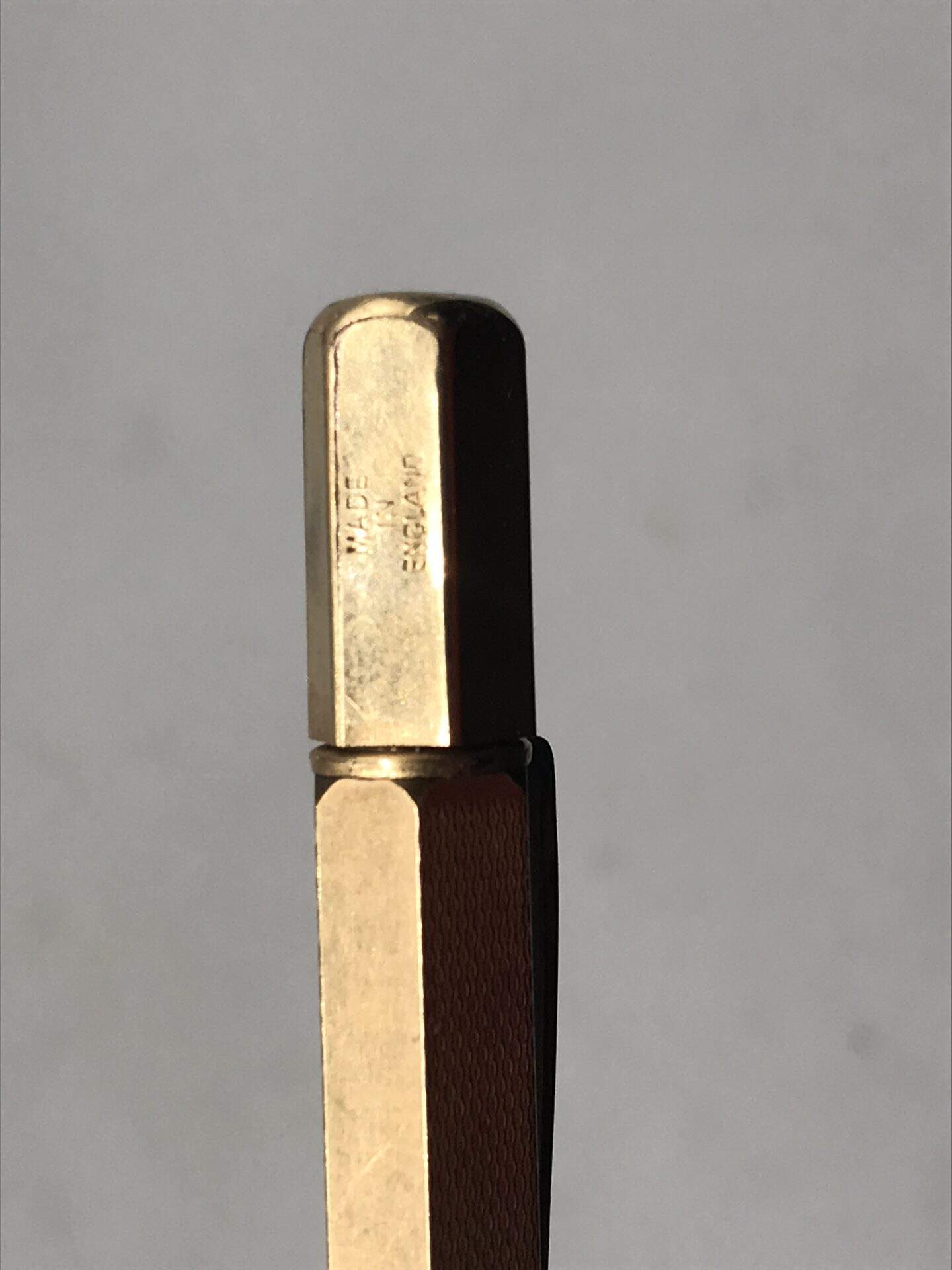 Close-up of mid-century rolled gold propelling pencil showing “Made in England” hallmark on top