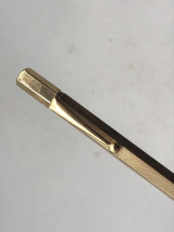 Close-up of antique British rolled gold pencil showing pocket clip and “Rolled Gold” mark near the top