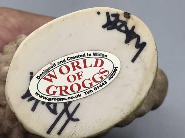 Base of Grogg sheep figurine showing World of Groggs label and John Hughes signature