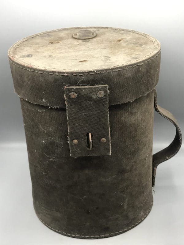 Early 20th century canvas and steel mining explosives canister with side handle and locking clasp, standing 11 inches tall with an 8.75-inch diameter
