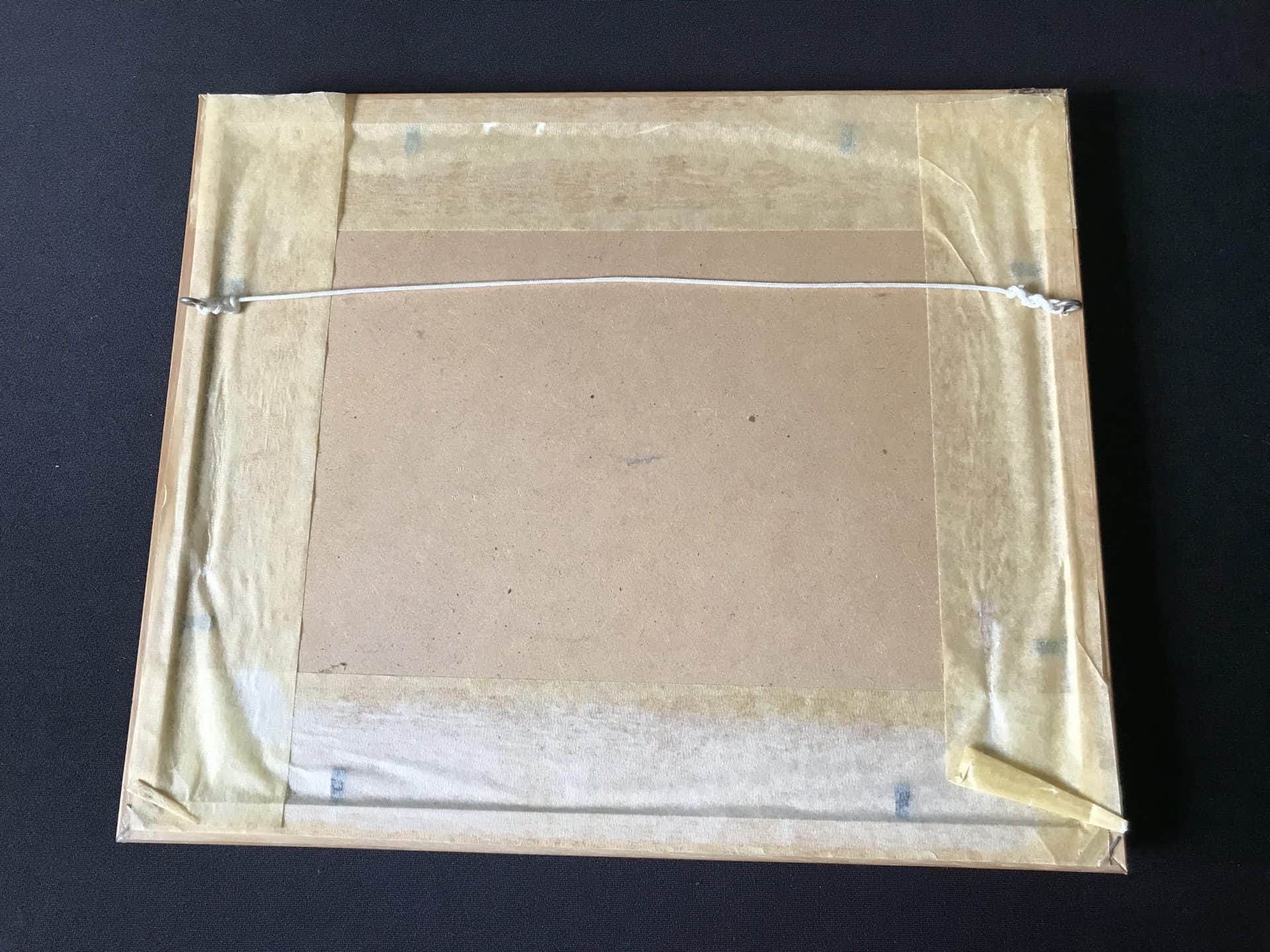 Back of framed English snow scene watercolour signed “Tom Menard,” showing cardboard backboard, old gummed tape and hanging cord; frame 12 × 10 inches