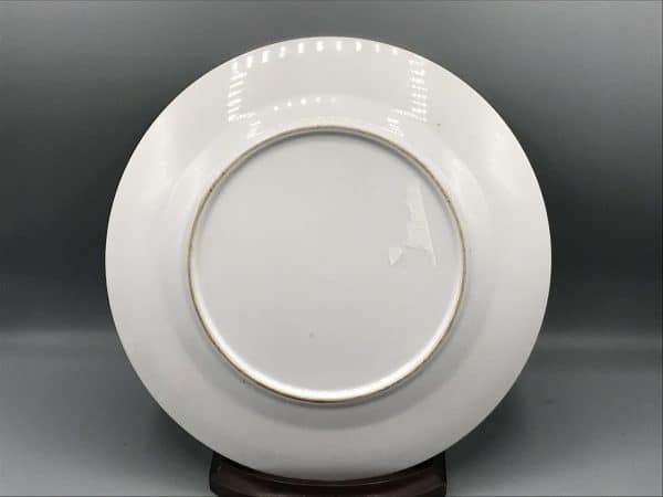 Back view of vintage Japanese porcelain plate with plain white surface and unmarked base