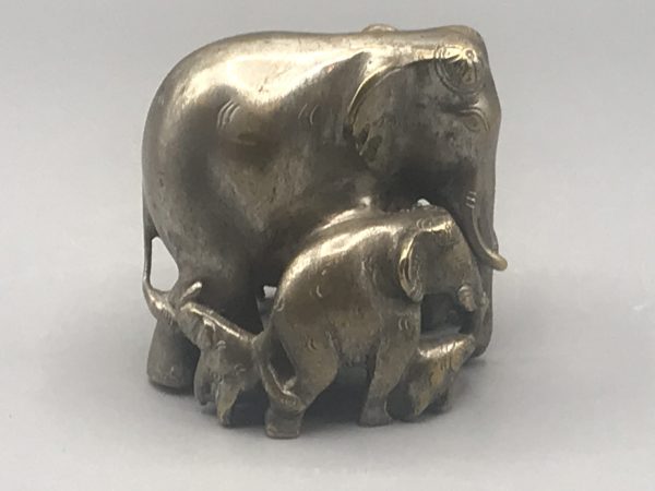 Early 20th-century Indian antique brass elephant family sculpture other side view showing central elephant with surrounding calves, remnants of original silver wash, about 3.75 inches tall
