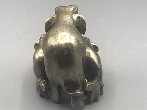 Early 20th-century Indian antique brass elephant family sculpture back view showing central elephant and surrounding calves, with remaining silvered highlights, approximately 3.75 inches tall