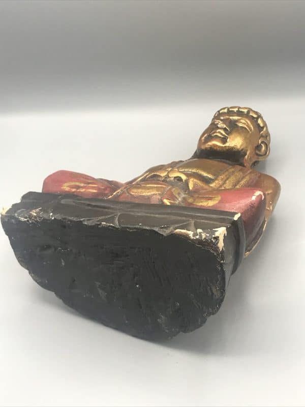 Base view of antique hand-carved wooden Buddha statue with gold gilt and red accents, showing the underside and construction details, approximately 12 inches tall