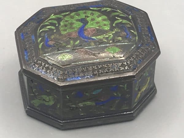 Antique silver enamel snuff box, front view, featuring peacock and floral enamel design with age-related wear