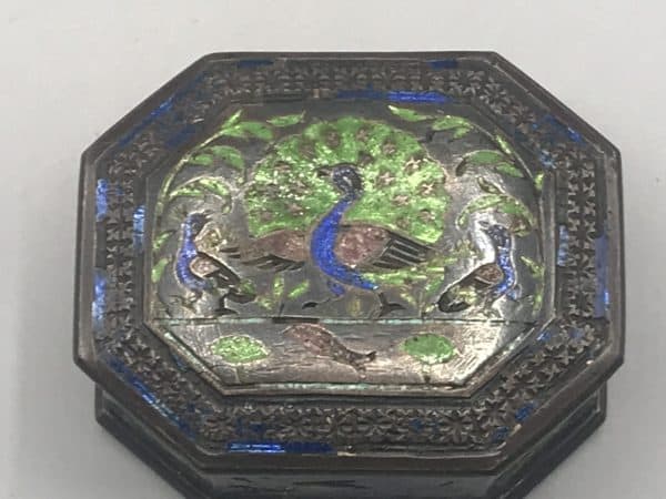 Antique silver enamel snuff box, top view, showing octagonal lid with colorful bird and floral enamel decoration