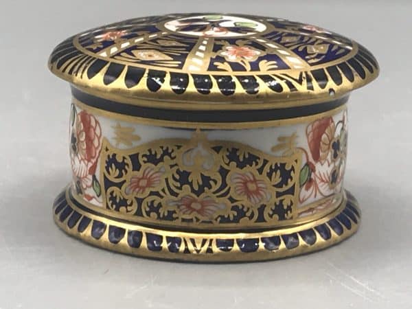 Royal Crown Derby porcelain Imari trinket pot, side view showing floral and gilt decoration in cobalt blue, iron red, and gold