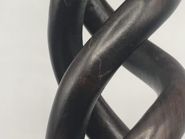 Close-up of antique ebony barley twist candlestick showing tight hairline crack on open spiral strand, Victorian period