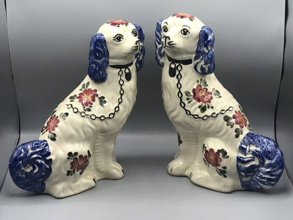 Pair of vintage Staffordshire spaniel dogs by Siltone Pottery, hand painted ceramic figures with collars, chains, and floral decoration, each measuring 11.5 inches tall, shown facing forward