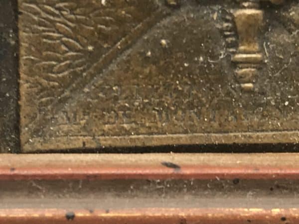 Close-up of signature “Aimé-Decoin” on 19th-century French bronze relief plaque after Clodion, showing artist’s mark and surface patina.