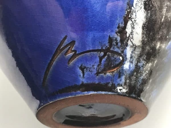 Close-up of the signature on a studio pottery vase by Planas Marquès, Pals Spain, showing the maker’s mark etched into the cobalt blue glaze near the base.