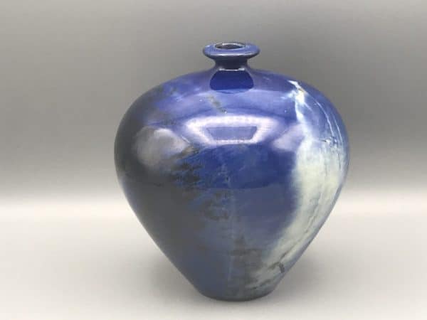 Modern studio pottery vase by Planas Marquès, Pals Spain, with rounded form and deep cobalt blue glaze accented by pale white streaking, approximately 6.5 inches tall.