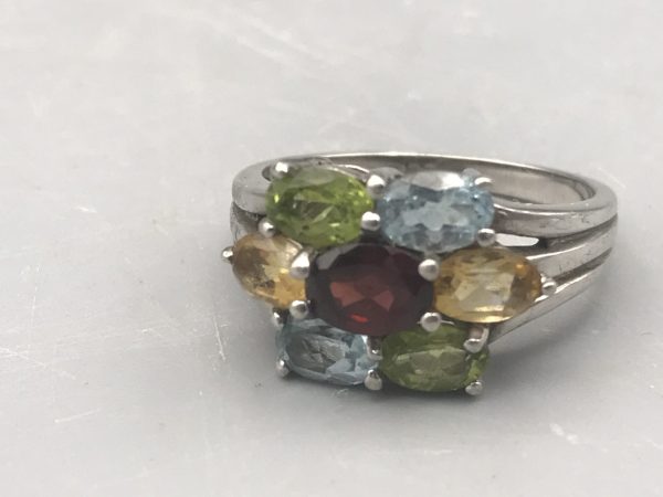Sterling silver 925 ring featuring an oval-cut multi-gemstone cluster of garnet, citrine, peridot, and blue topaz stones in a floral arrangement.