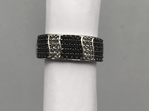 Front view of a sterling silver TGGC ring with alternating rows of black and white pavé-set stones, displayed on a ring mandrel.