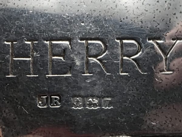 Close-up of hallmarks on sterling silver sherry decanter label by John Rose, Birmingham 1968, showing maker’s mark JR, lion passant, anchor, and date letter.