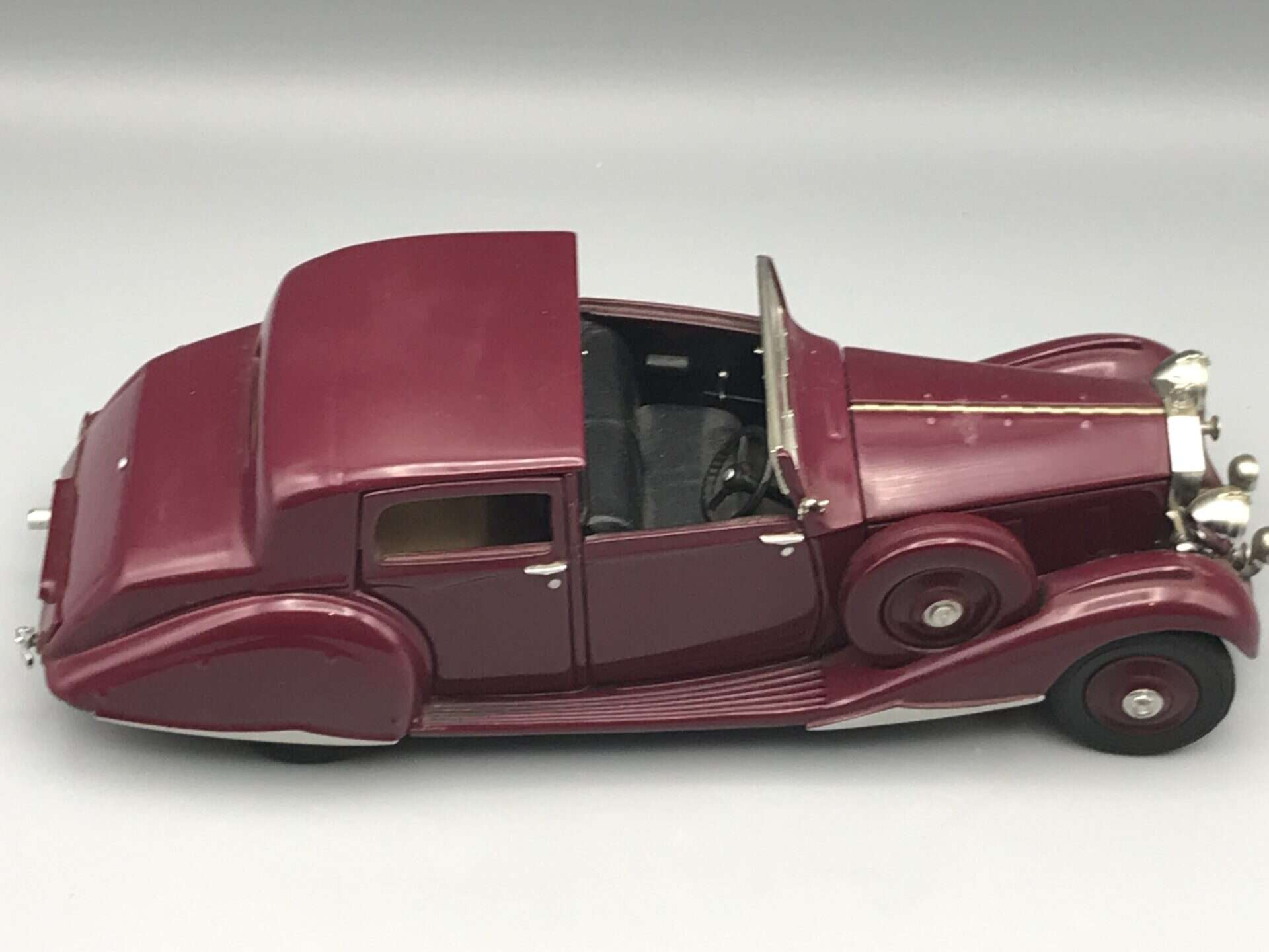 Side view of Danbury Mint 1938 Rolls-Royce Phantom III Sedanca de Ville die-cast model in garnet finish