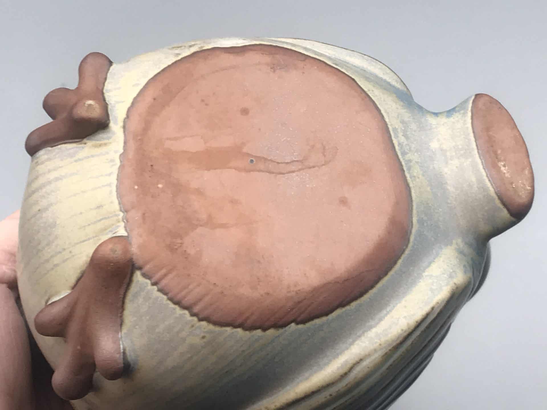 Base view of Kashiwa Craft Seto ware owl teapot showing unglazed red clay underside and foot detail, Japanese studio pottery