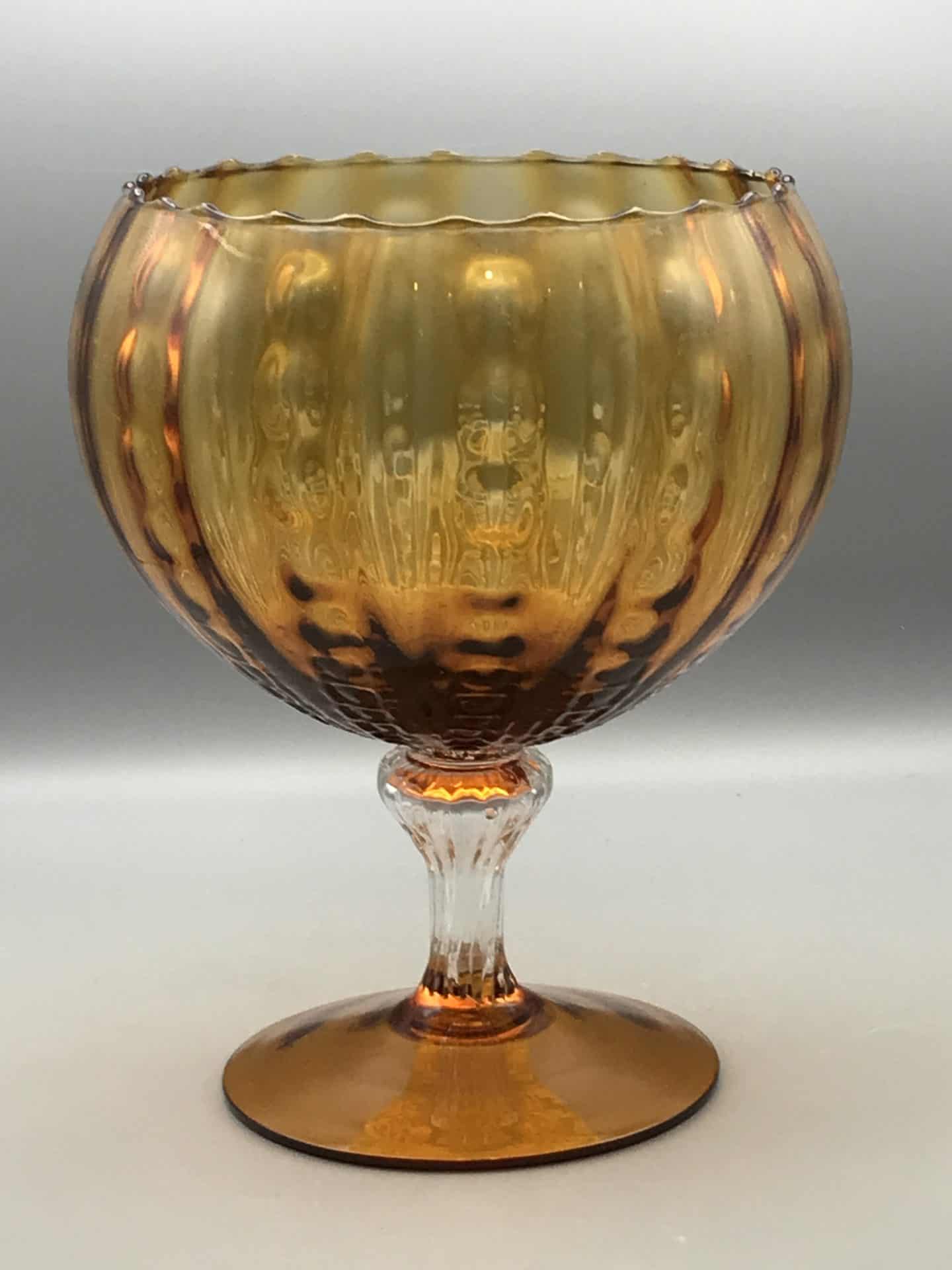 Mid century Empoli amber glass vase with ribbed bowl and clear moulded stem measuring 9.25 inches tall