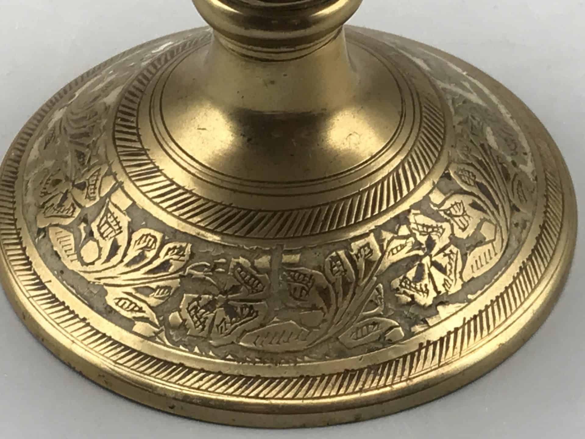 Close-up of the engraved pedestal base on the antique Indian brass rose bowl