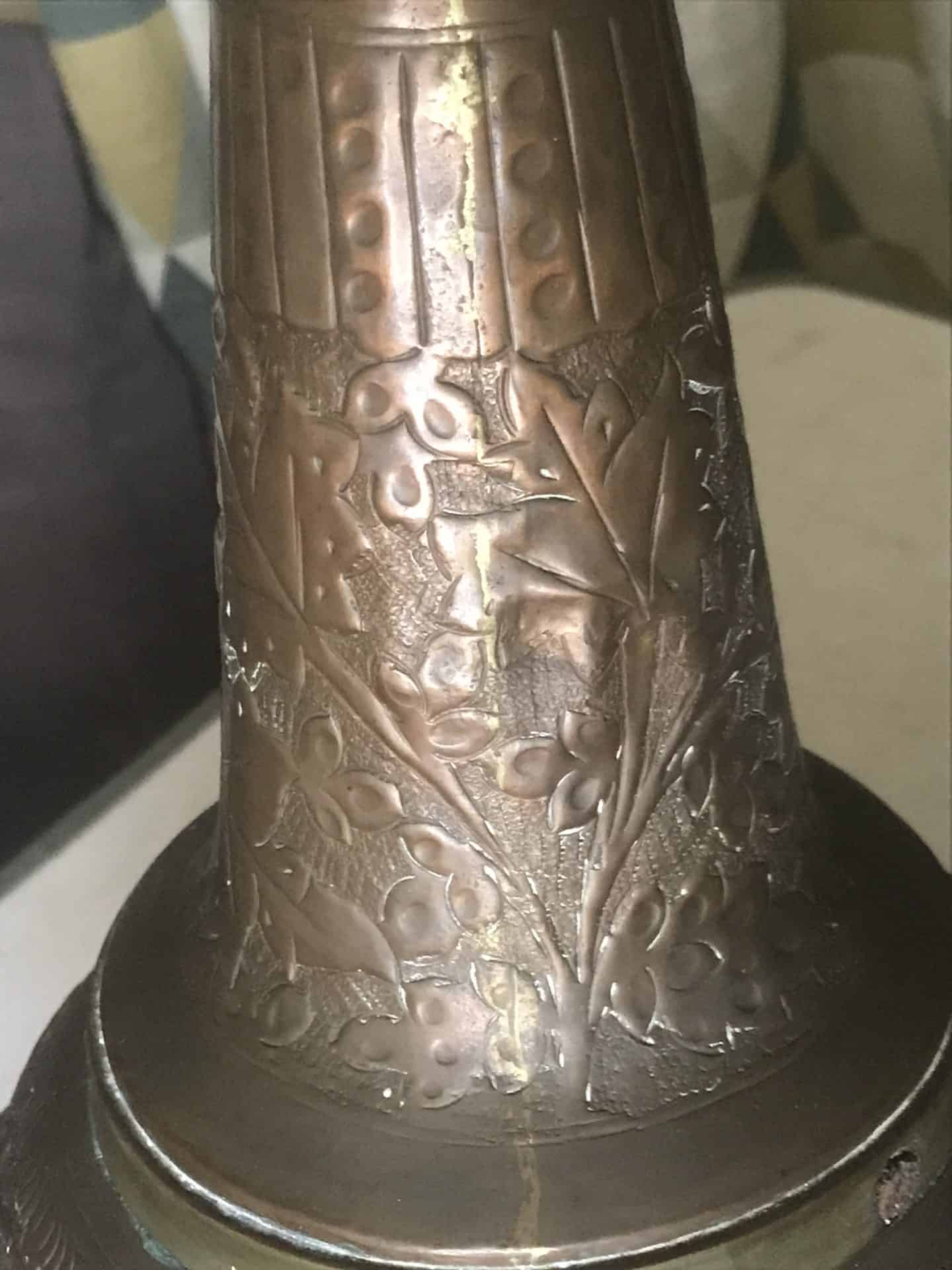 Vertical seam on the baluster neck of a monumental Ottoman copper ewer showing hand-raised construction and floral repoussé decoration