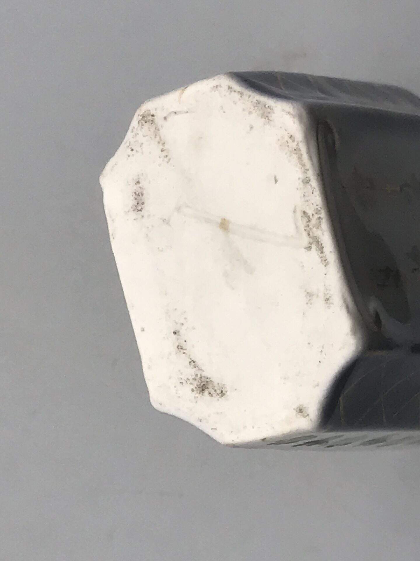 19th century French porcelain scent bottle base showing unmarked underside and wear consistent with age